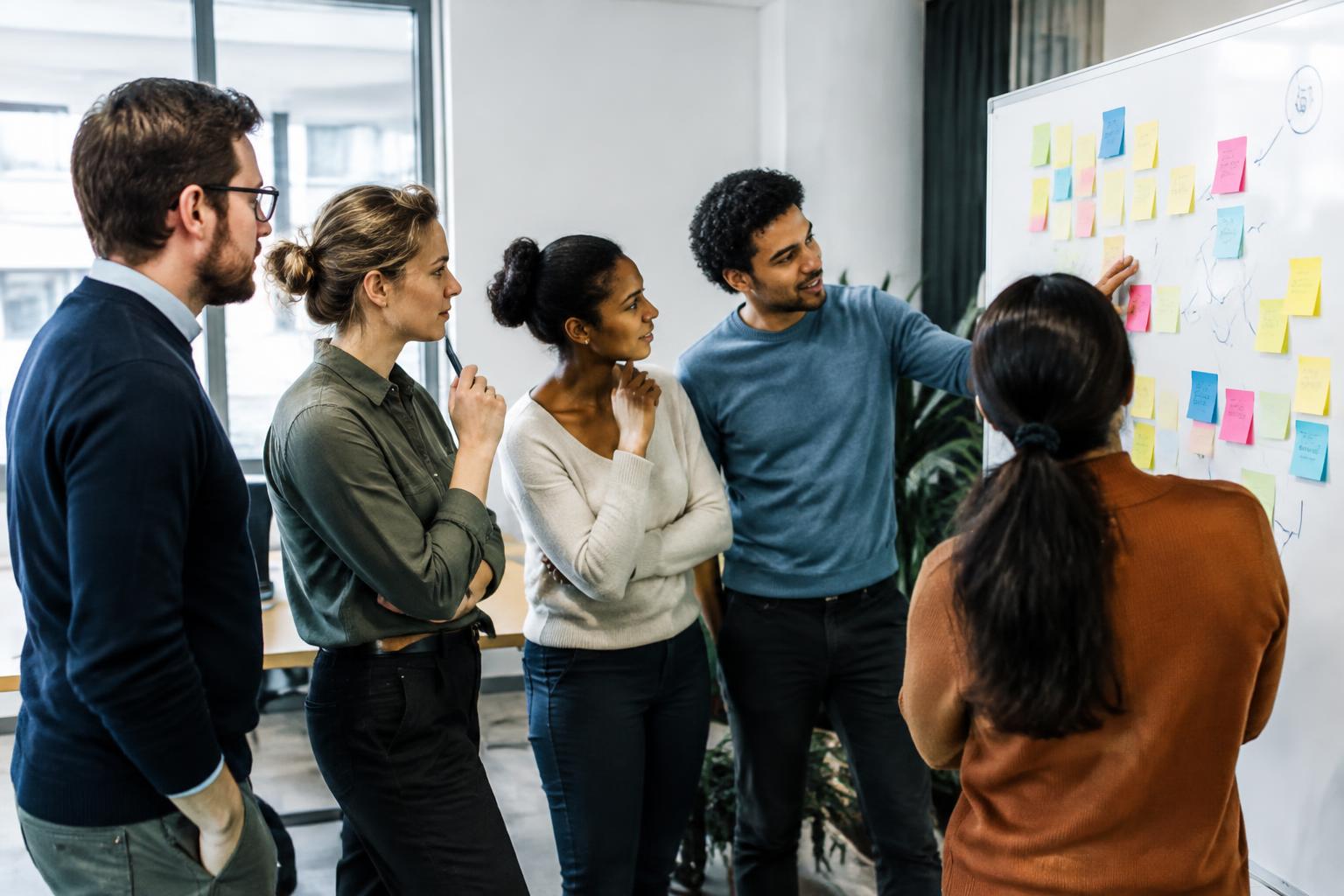 Mixed team brainstorming at a whiteboard